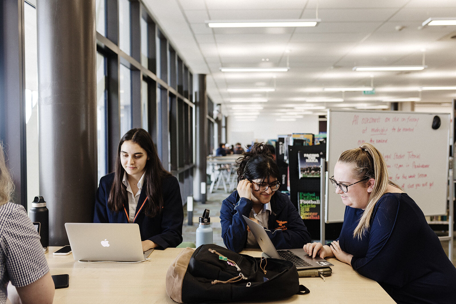 Photo of students sitting at a desk studying