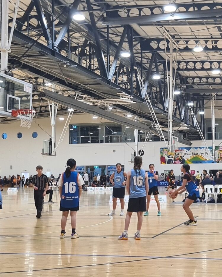 Girls basketball game in action on an indoor court
