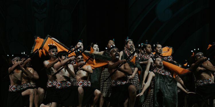 Rototuna High School kapa haka group performing a haka with traditional dress and intense expressions.
